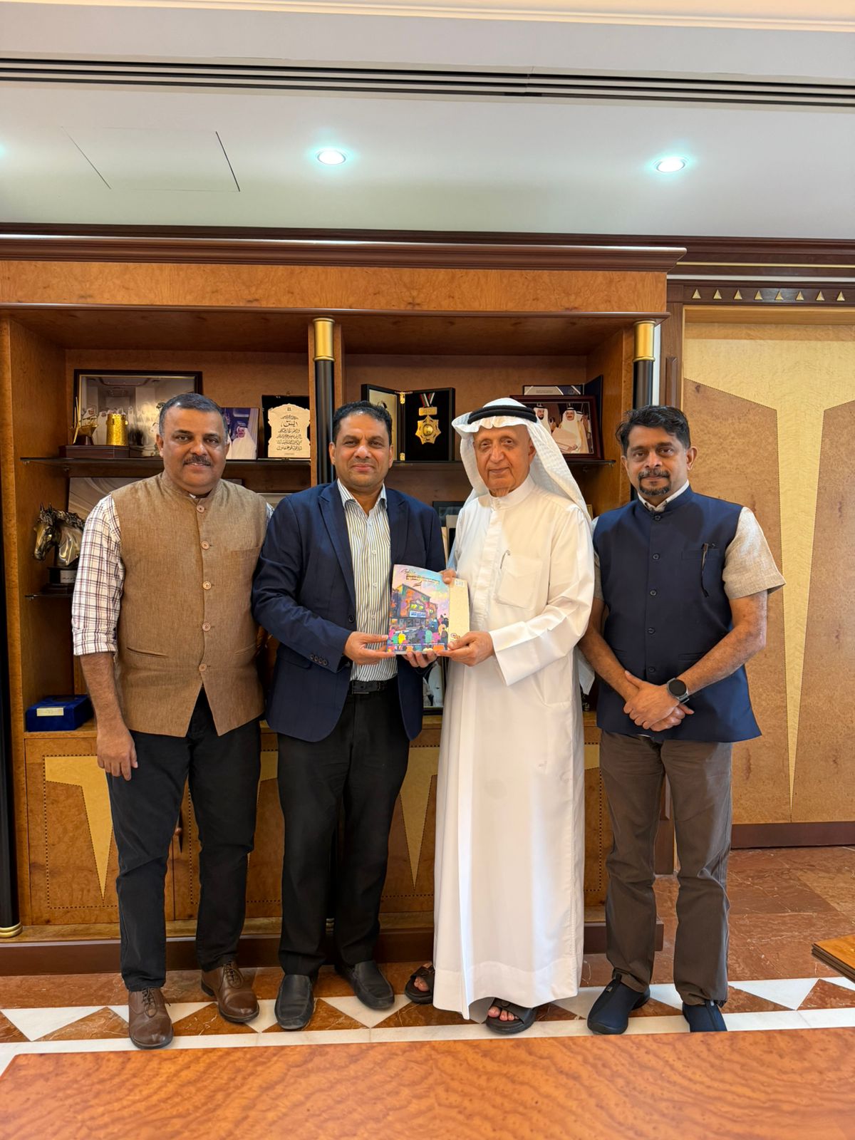Book handover ceremony to dignitary in UAE office